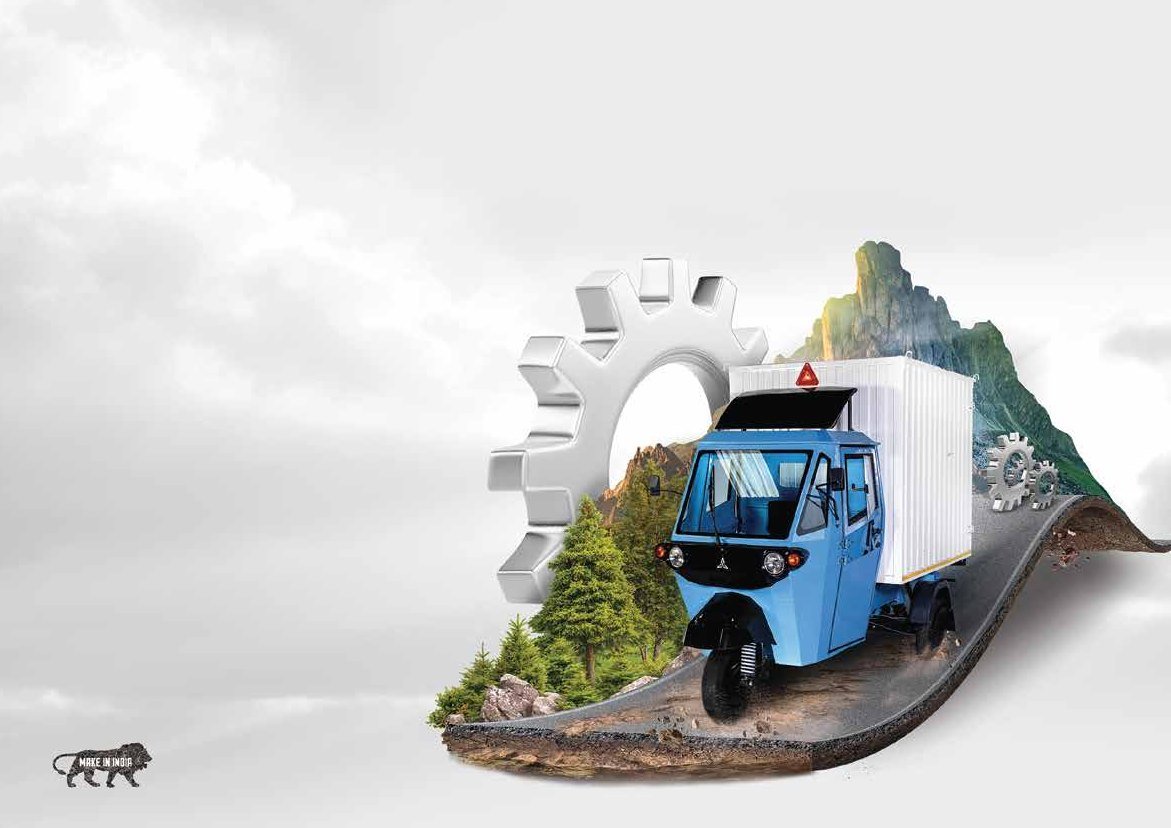 Navya key visual: the blue cargo three-wheeler on a mountain road unrolling from a white gear, with the Make in India mark