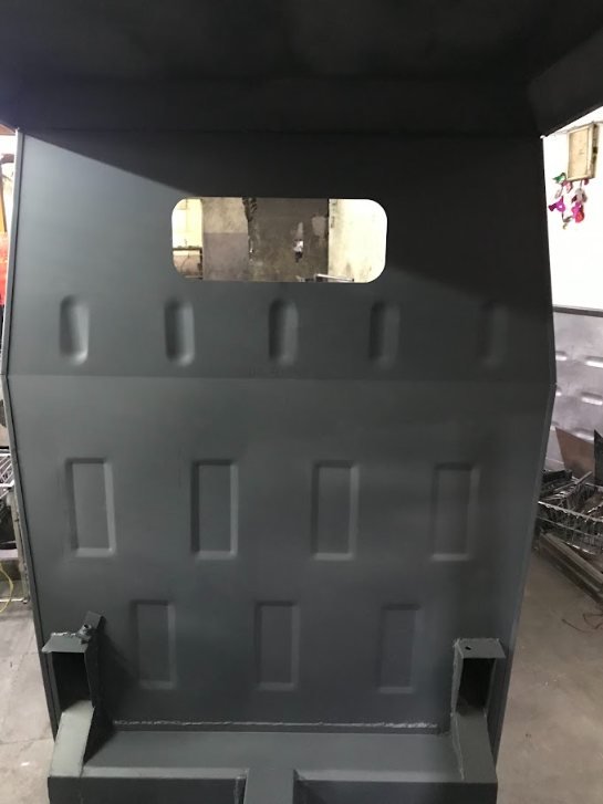 Black-and-white photo of the ribbed rear cab panel fresh off the tools