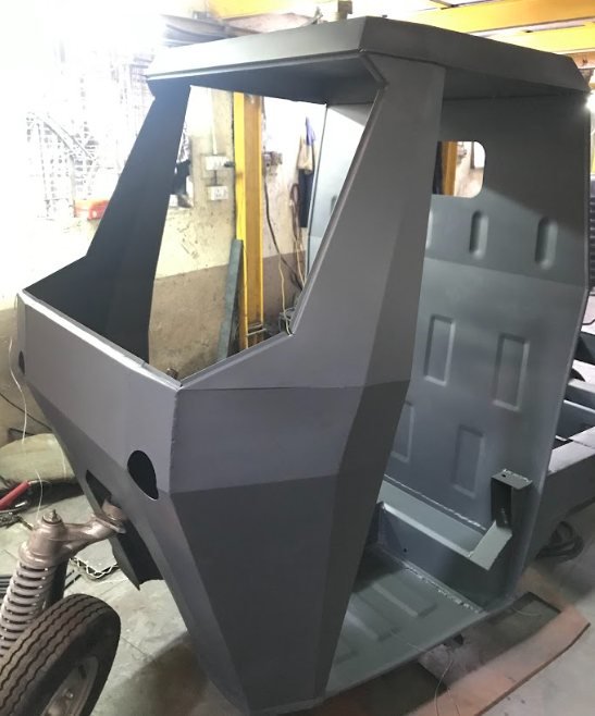 The faceted folded cab finished in dark primer