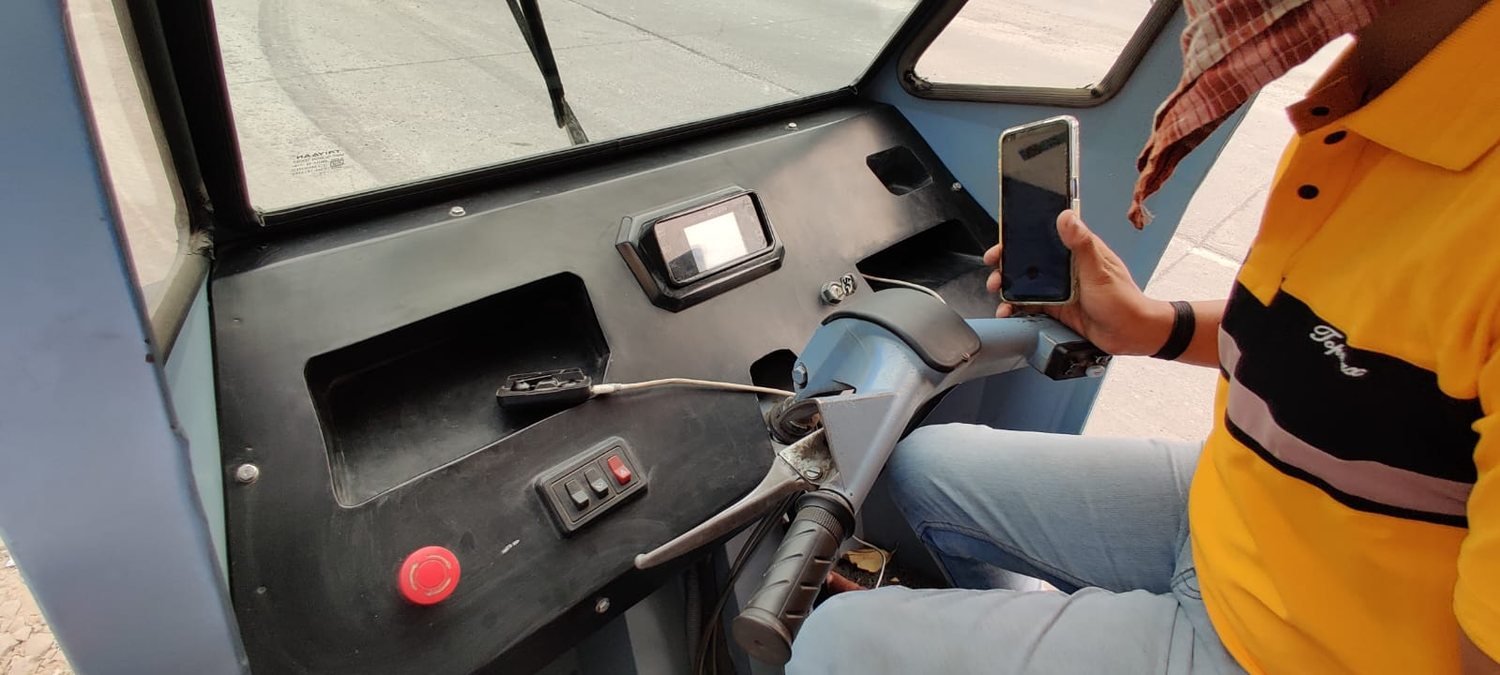 The black FRP dashboard prototype installed in the cab, with cluster, switches and emergency stop
