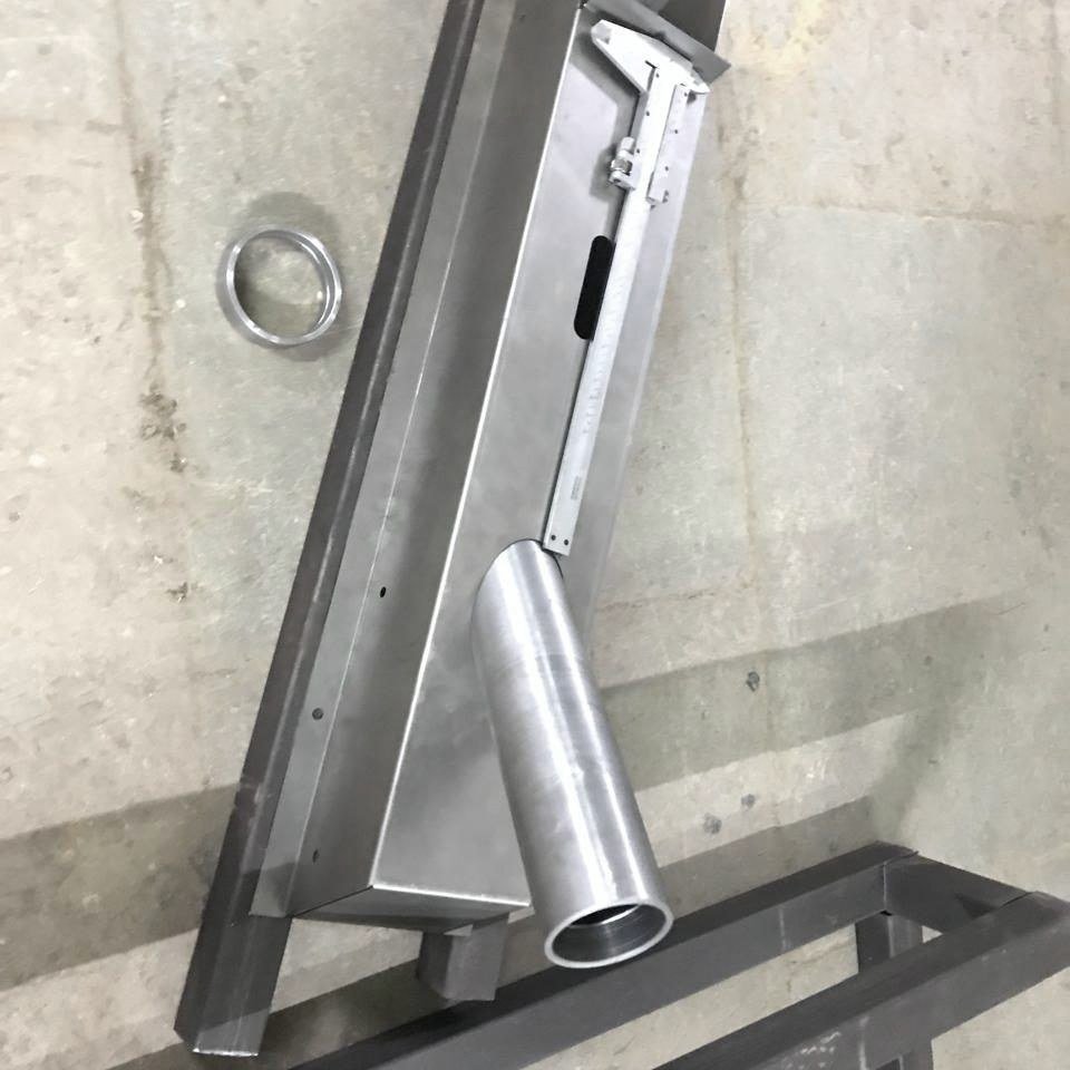 A welding fixture holding a Navya chassis member
