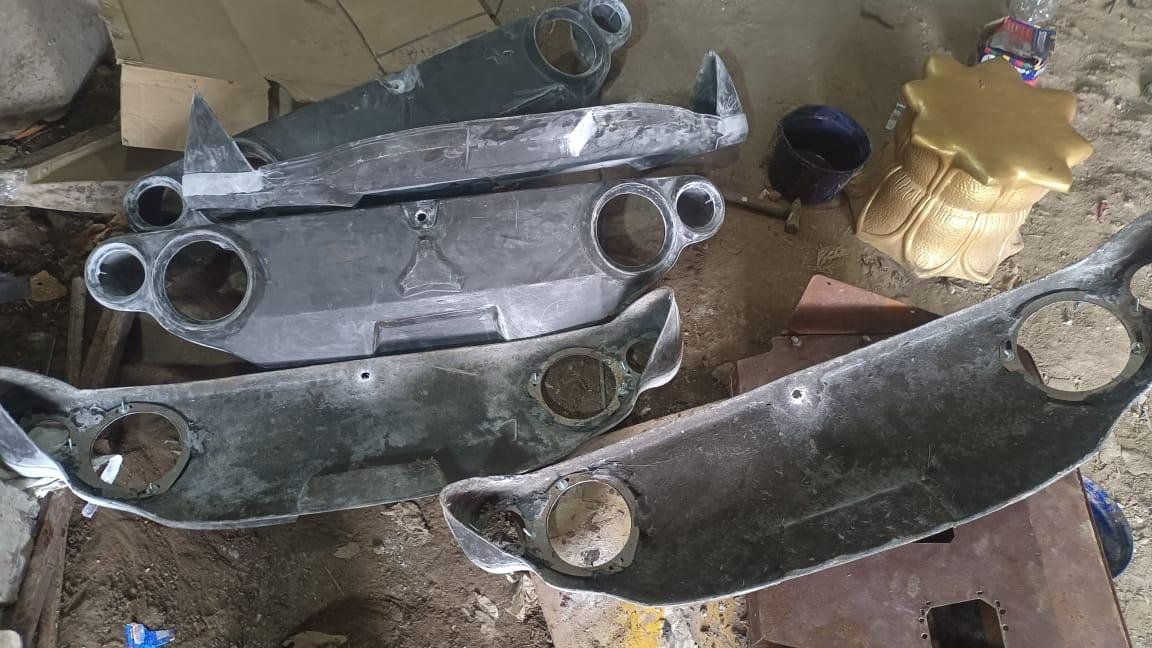 A stack of FRP housing pulls in various states of finish