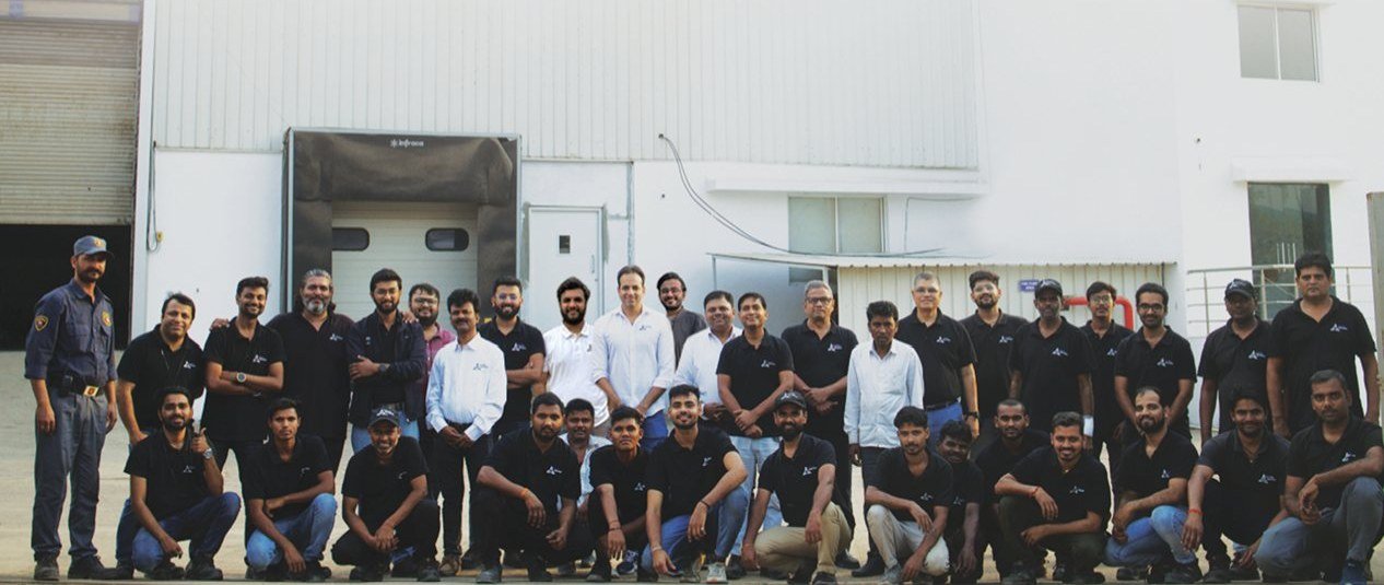 The Astro Motors team gathered outside the factory loading dock