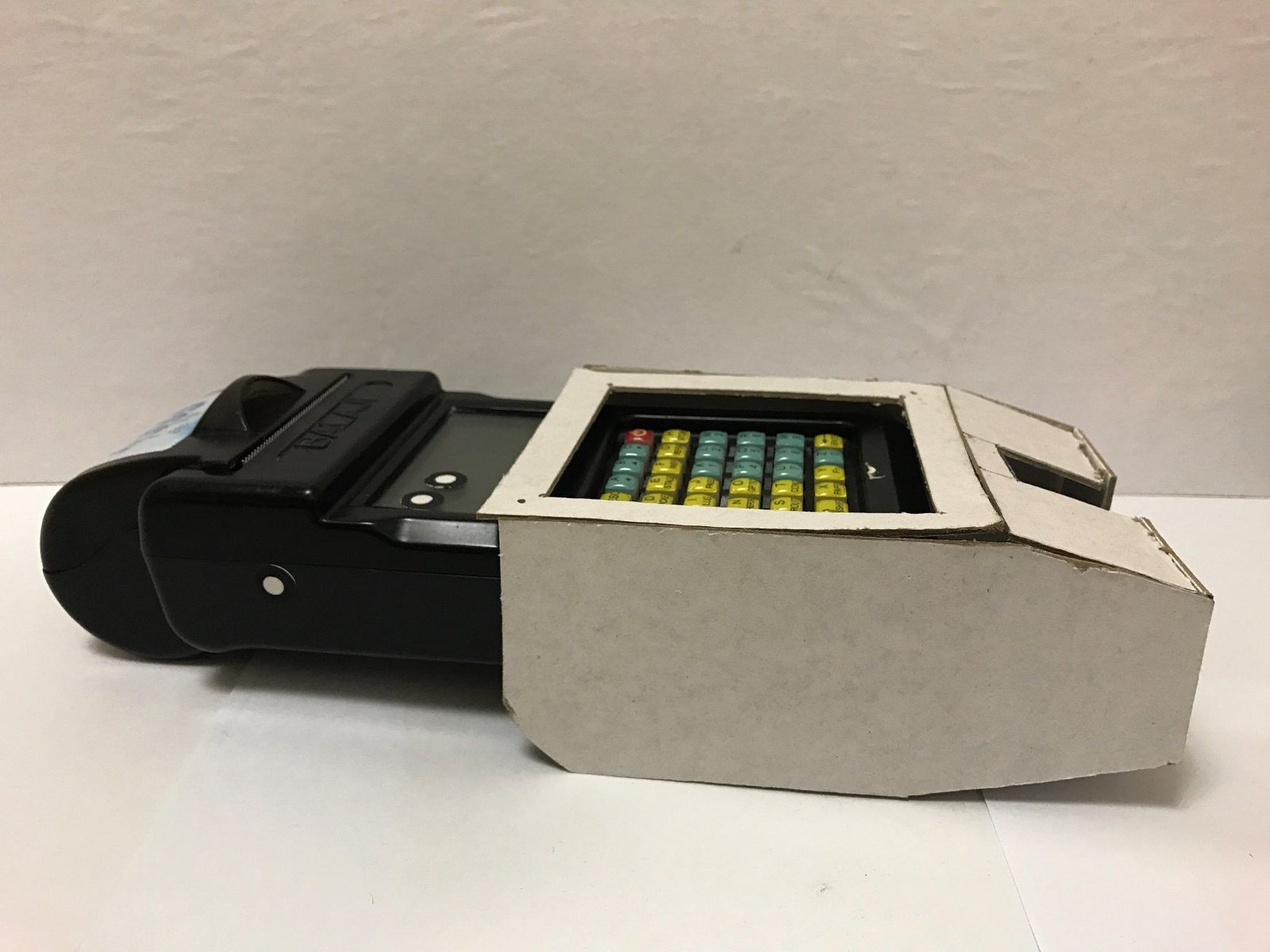 Black handheld Wi-Fi ticketing device with a keypad, in a card mock-up sleeve