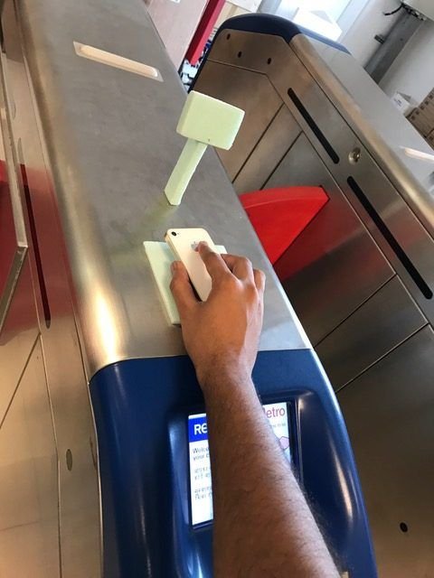 A foam mock-up beside the red flap, hand holding a phone
